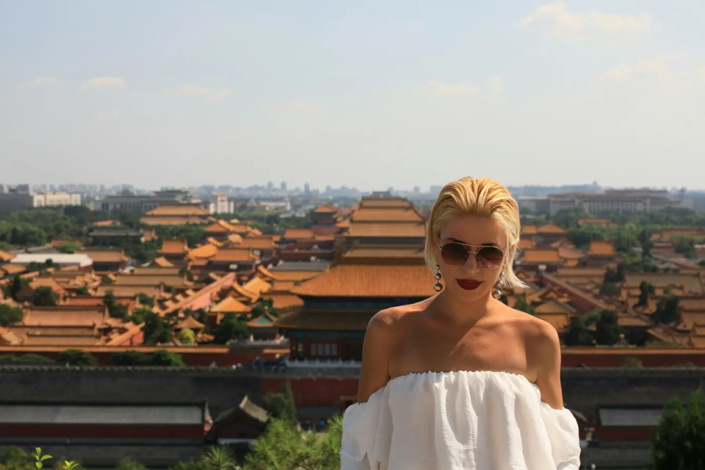 Traveler overlooking palace rooftops in Beijing